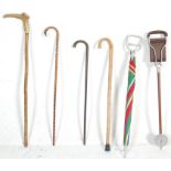 A GROUP OF RETRO WALKING STICKS AND SHOOTING STICKS