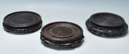 GROUP OF THREE CHINESE HARDWOOD VASE STANDS