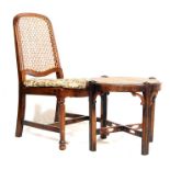 AN EARLY 20TH CENTURY ANTIQUE OAK FIRESIDE CHAIR AND FOOTSTOOL