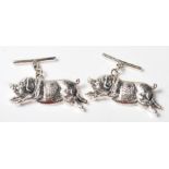 A PAIR OF STAMPED STERLING SILVER CUFFLINKS IN THE FORM OF TWO PIGS.