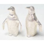 A SILVER PLATED CRUET SET IN THE FORM OF PAIR OF PENGUINS.