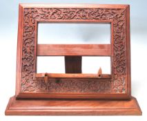 A RETRO LATE 20TH CENTURY INDIAN TEAK WOOD MENU HOLDER / BOOK HOLDER.