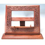 A RETRO LATE 20TH CENTURY INDIAN TEAK WOOD MENU HOLDER / BOOK HOLDER.