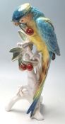 KARL ENS - CERAMIC PORCELAIN FIGURINES OF A PARROT EATING CHERRIES