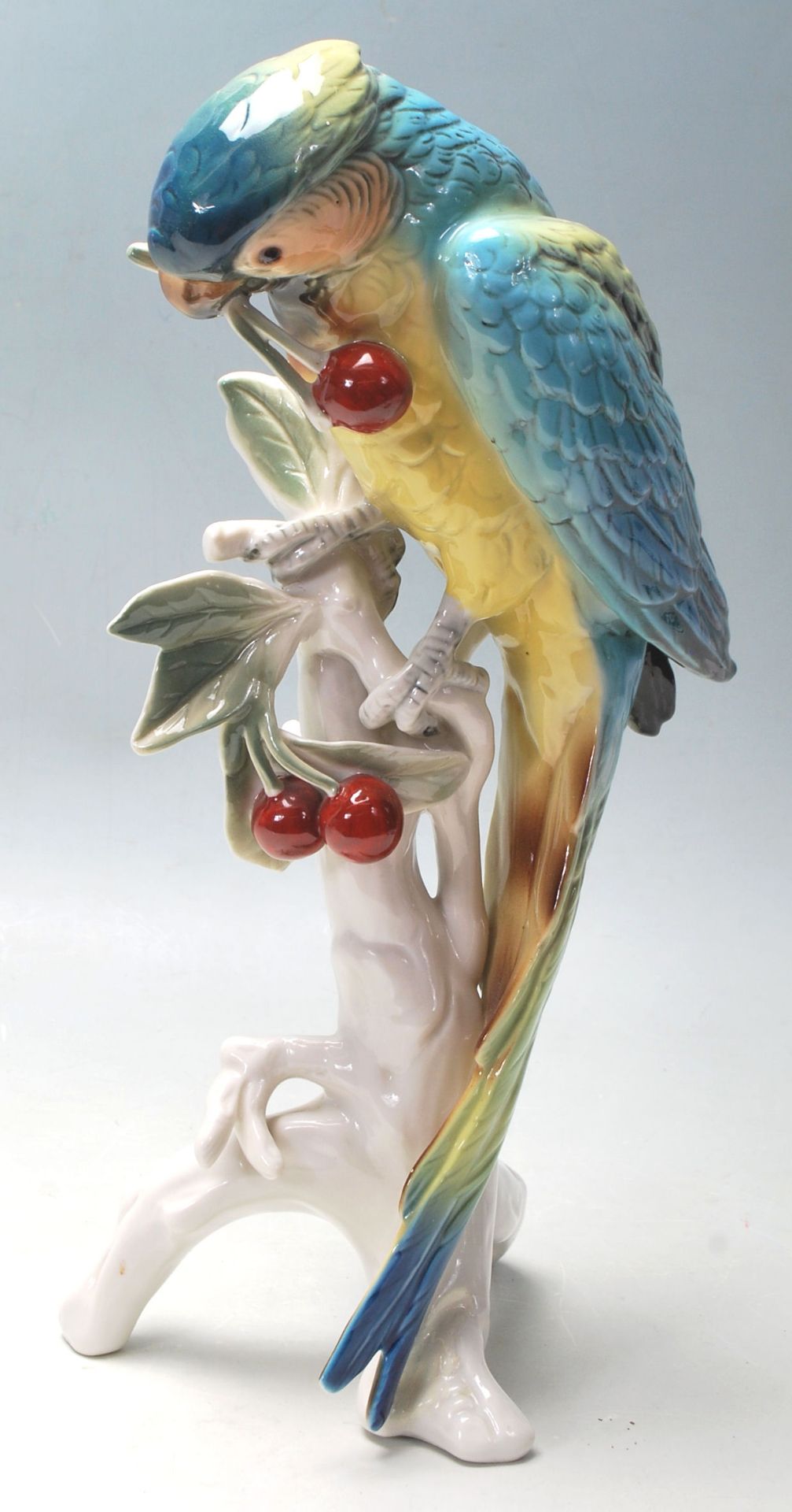 KARL ENS - CERAMIC PORCELAIN FIGURINES OF A PARROT EATING CHERRIES