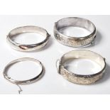 FOUR VINTAGE SILVER ENGRAVED BANGLES