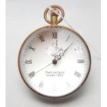 A SPHERICAL SWISS GLASS CLOCK HAVING BRASS BANDING AND EXPOSED WORKINGS.