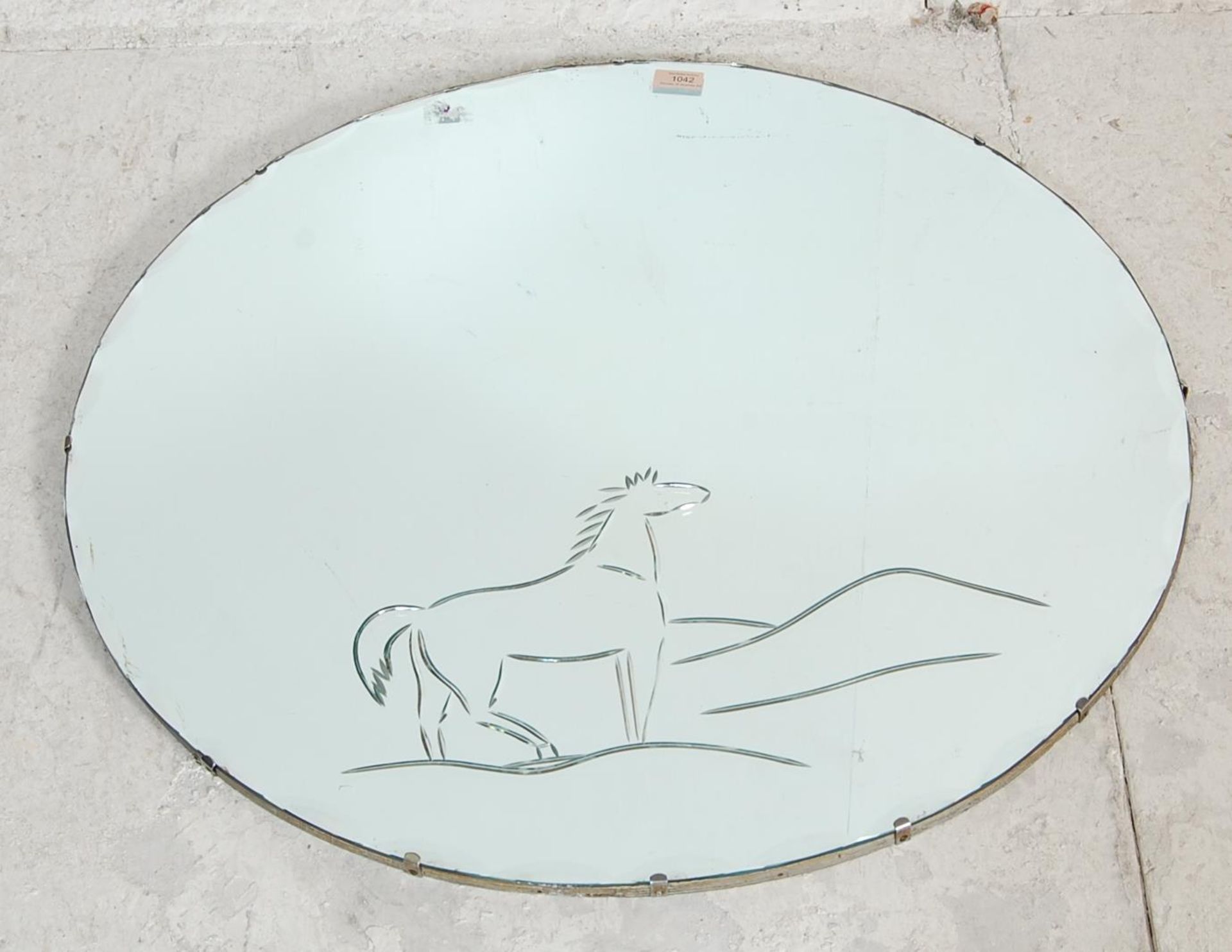 A RETRO LARGE CIRCULAR MIRROR WITH ETCHED HORSE AND LANDSCAPE AND BEVELLED EDGE.