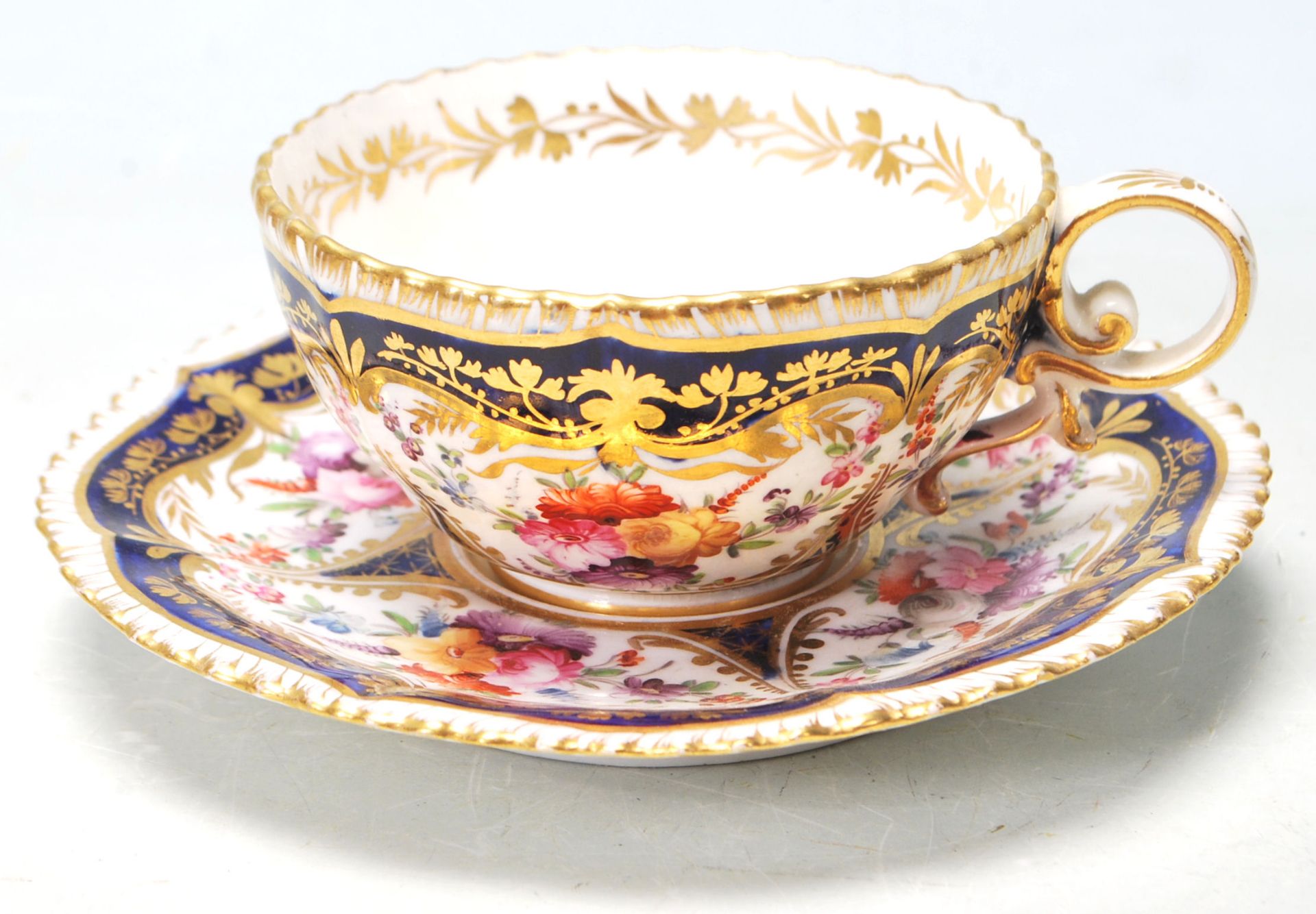 A 19TH CENTURY GEORGIAN COBALT BLUE AND GILT TEA CUP AND SAUCER