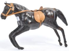 A VINTAGE LEATHER MODEL OF A HORSE WITH SADDLE