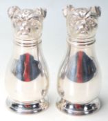 A SILVER PLATED CRUET SET IN THE FORM OF A PAIR OF