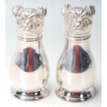 A SILVER PLATED CRUET SET IN THE FORM OF A PAIR OF