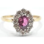 A STAMPED 14K YELLOW GOLD RUBY AND DIAMOND RING OF