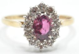 A STAMPED 14K YELLOW GOLD RUBY AND DIAMOND RING OF