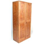 A RETRO 20TH CENTURY PINE SCOOL CUPBOARD