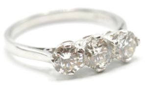 A WHITE GOLD THREE STONE DIAMOND RING.