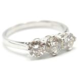 A WHITE GOLD THREE STONE DIAMOND RING.