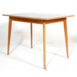 MID CENTURY TEAK AND FORMICA TOPPED DINING TABLE