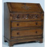 A JACOBEAN REVIVAL OAK WRITING BUREAU DESK