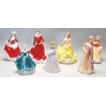 A GROUP OF SEVEN ROYAL DOULTON CERAMIC FIGURINES - HN 5322 - HN 5321 - HN 5314 - HN 5323 - HN 5229 -