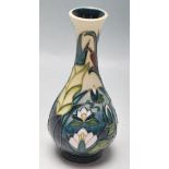 A MOORCROFT VASE OF BALUSTER FORM WITH FLORAL MOTIFS