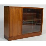 A VINTAGE MID CENTURY TEAK WOOD BOOKCASE WITH SLIDING GLASS DOORS