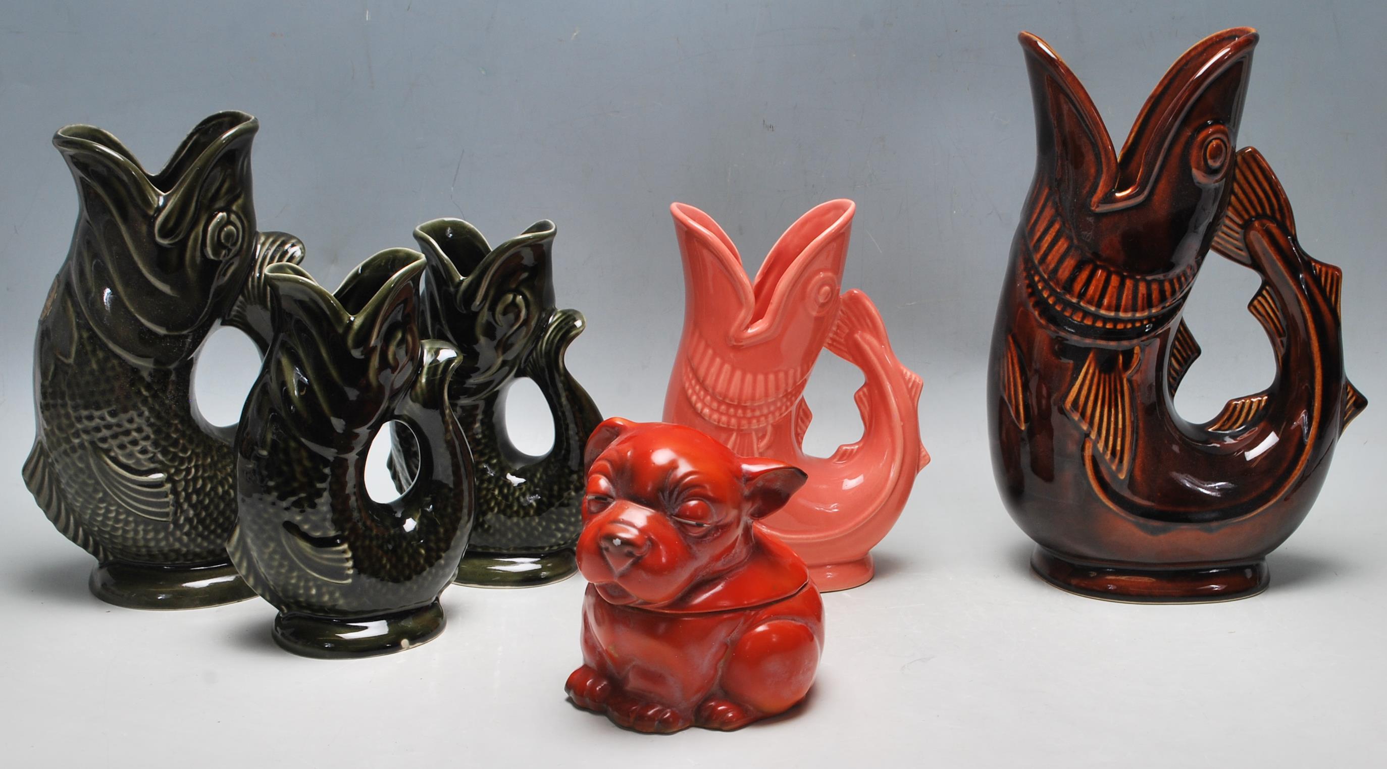 A COLLECTION OIF FIVE CERAMIC GUGGLE JUGS BY DARTMOUTH AND SHREVE