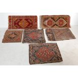 A GROUP OF SEVEN SMALL PERSIAN ISLAMIC RUGS
