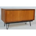 A RETRO 1970’S TEAK WOOD CABINET WITH SLIDING DOORS AND HAIRPIN LEGS