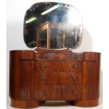 A 1930’S ART DECO WALNUT DRESSING TABLE WITH BEVELLED MIRROR AND METAMORPHIC DRAWER