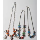 THREE SILVER BEADED CHARM NECKLACES.