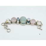 A hallmarked 925 moonstone, rose quartz, topaz and baroque pearl bracelet. The bracelet set with a