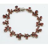 A HALLMARKED 925 SILVER AND GARNET BRACELET