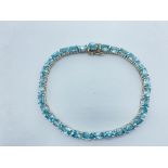 A HALLMARKED 925 SILVER & BLUE ZIRCON BRACELET