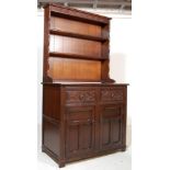 An antique style Jaycee Jacobean revival oak welsh dresser having a flared top over 3 shelves set on