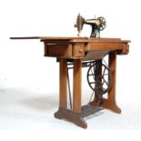 A LATE 19TH CENTURY VICTORIAN SINGER SEWING MACHINE TABLE