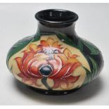 A VINATGE MOORCROFT VASE OF BALUSTER FORM WITH FLORAL MOTIFS DECORATION RAISED ON CIRCULAR FOOT