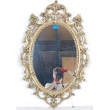 A 20TH CENTURY ANTIQUE STYLE GILDED WALL MIRROR WITH FOLIATE DESIGN