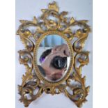 AN ANTIQUE BRASS ORNATE DRESSING TABLE MIRROR