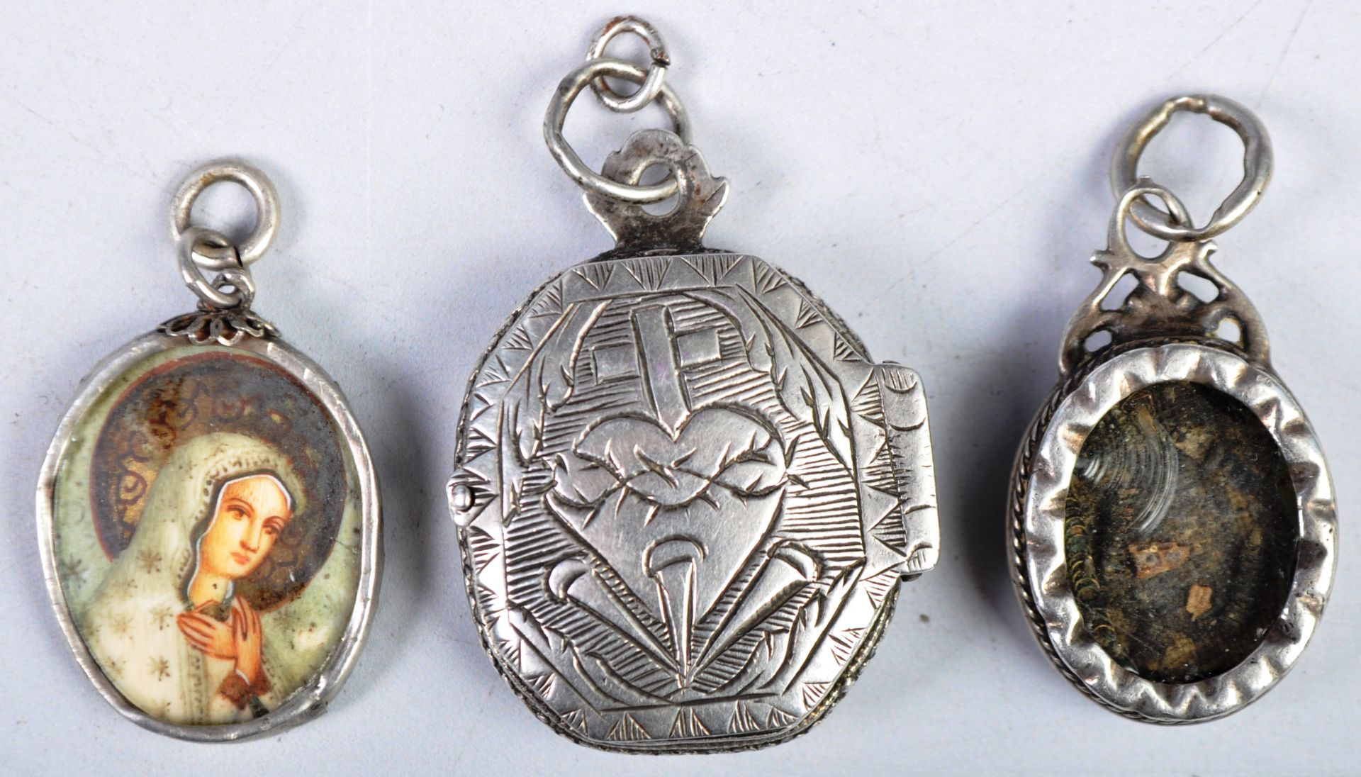 COLLECTION OF ANTIQUE RELIGIOUS SILVER LOCKETS AND PENDANTS