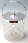 A CUT GLASS AND SILVER PLATE BISCUIT BARREL.