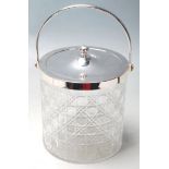 A CUT GLASS AND SILVER PLATE BISCUIT BARREL.