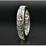 A HALLMARKED 18CT WHITE GOLD AND 5CT DIAMOND ETERNITY RING