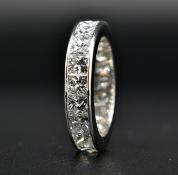 A HALLMARKED 18CT WHITE GOLD AND 5CT DIAMOND ETERNITY RING