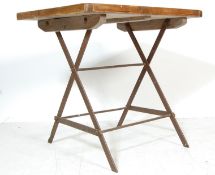 AN INDUSTRIAL RETRO TRESTLE TABLE CONSTRUCTED FROM RECLAINED PINE WOOD BOARDS AND METAL.