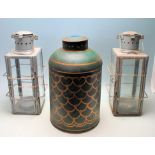 TWO VINTAGE RETRO 20TH CENTURY METAL AND GLASS CANDLE LANTERNS TOGETHER WITH A TEA CANISTER