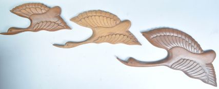 THREE MID CENTURY HAND CARVED TEAK WOOD FLYING DUCKS