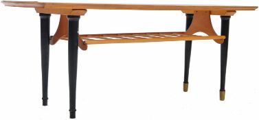 MID CENTURY ENGLISH TEAK WOOD COFFEE TABLE RAISED ON EBONISED SUPPORTS