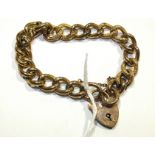 A 9ct gold bracelet of hollow engraved curb links, with padlock clasp, 16.8g.