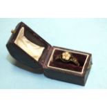 A Victorian mourning ring of 18ct gold with diamond and pearl cluster, the black enamelled shoulders